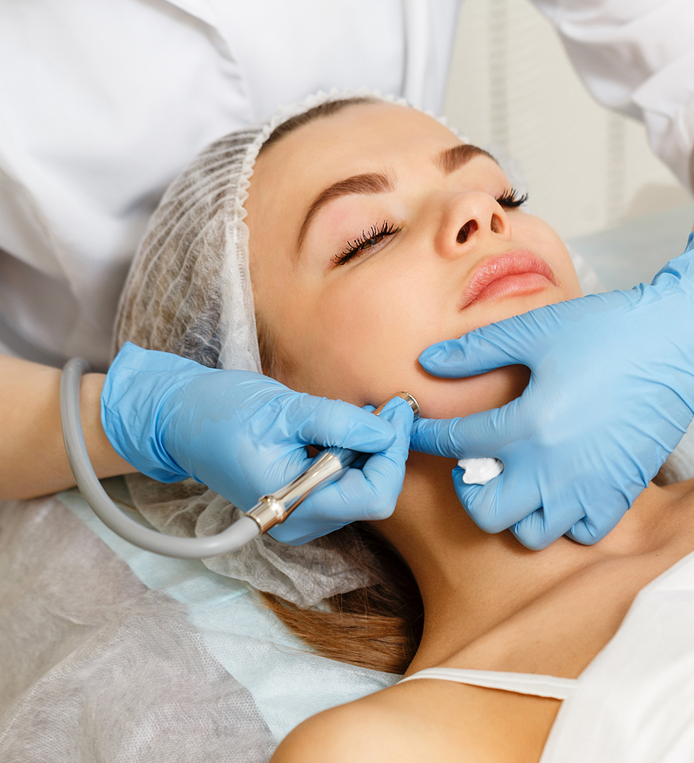 Woman receiving microdermabrasion facial